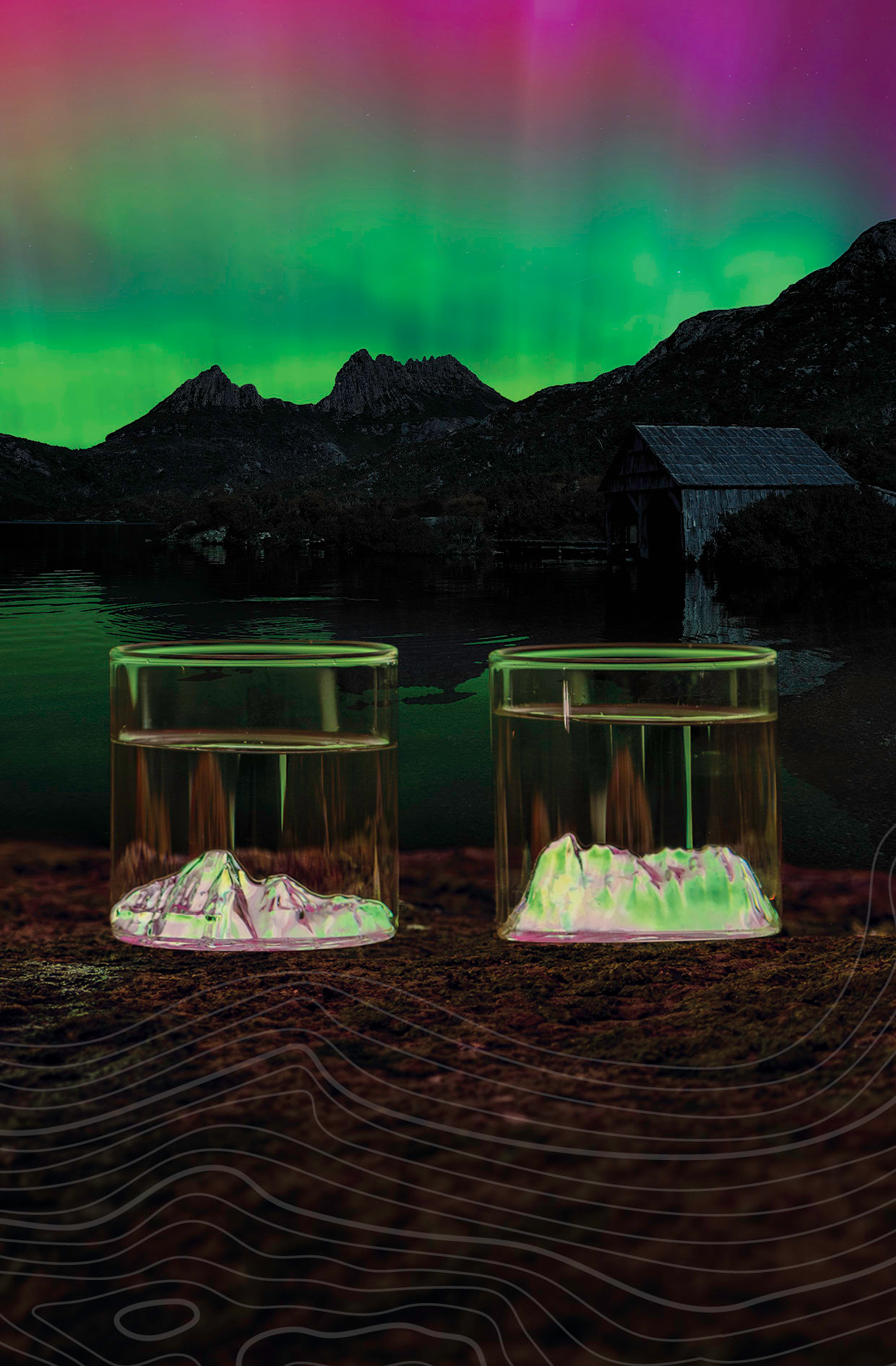 two uprising glasses with cradle mountain during an aurora australis